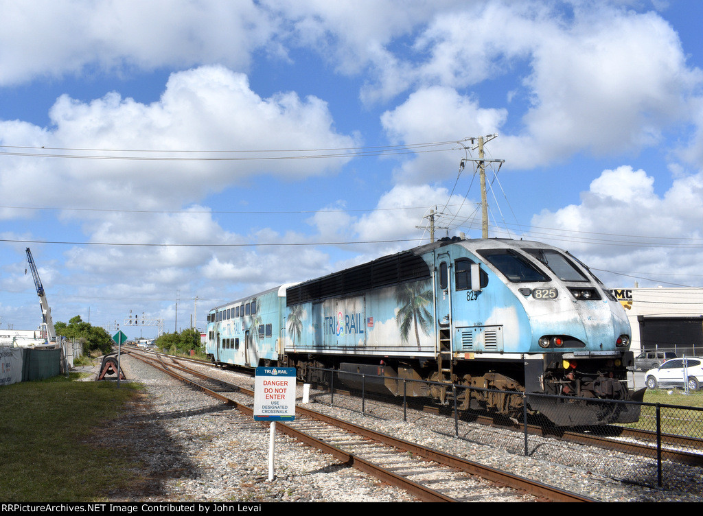 BL36PH # 825 pushes the Tri-Rail shuttle train away from Metrorail Transfer Station toward the yard just north of the depot